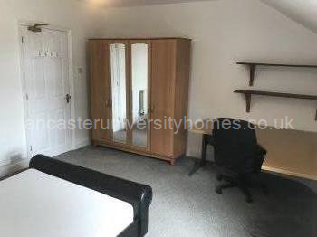 Top floor, front bedroom. Huge room with massive corner desk. 