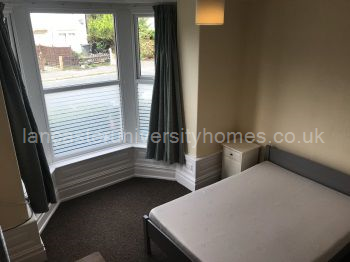 Ground floor, front bedroom with new privacy film on bottom half of windows. 