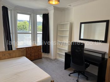 Ground-floor, front bedroom. Very nice size, new carpet and privacy covering on lower windows.