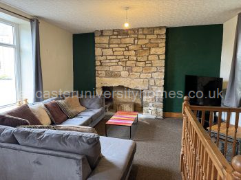 Middle-floor open-plan lounge & kitchen. L-shaped sofa and kitchen table & chairs bought in 2025. 52-inch smart tv. 