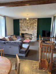 Middle-floor open-plan lounge & kitchen. L-shaped sofa and kitchen table & chairs bought in 2025. 52-inch smart tv. 